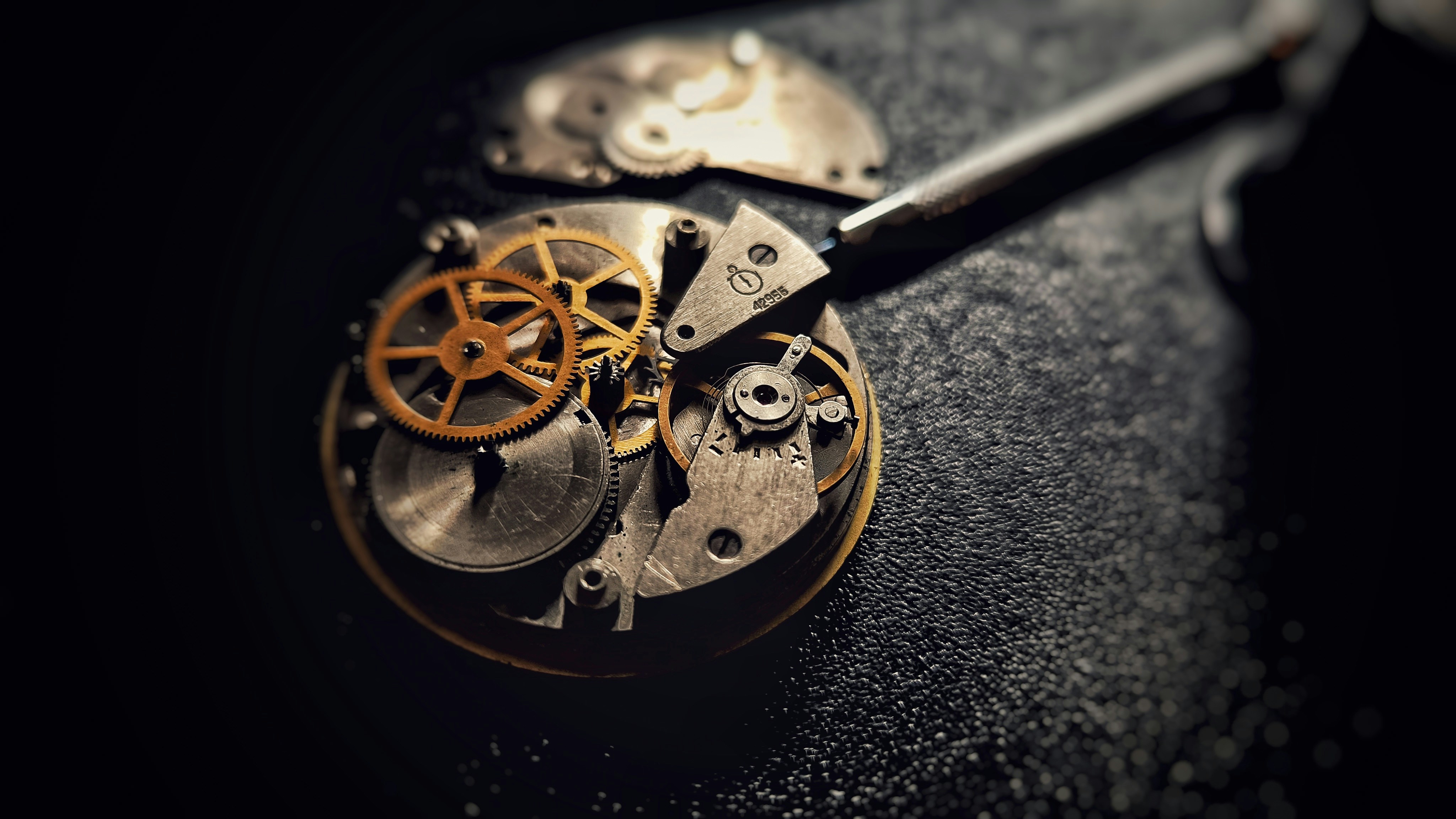 A watch being carefully cleaned with professional tools on a work surface